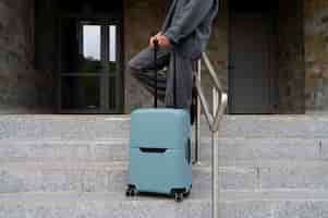 Free photo side view traveler with suitcase