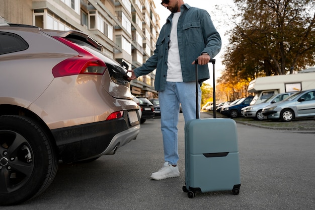 Free photo side view traveler with suitcase