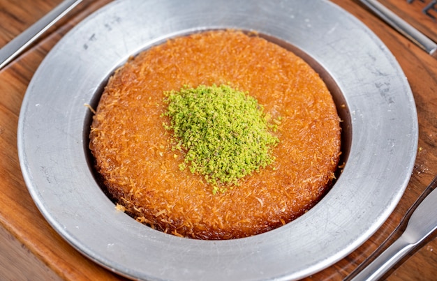 Side view of turkish traditional dessert kunefe on a plate