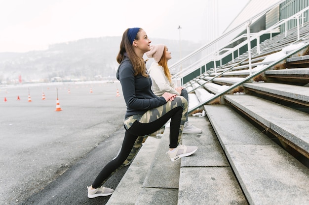 Free photo side view of two women working out in the winter