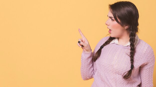 Side view of upset woman pointing finger
