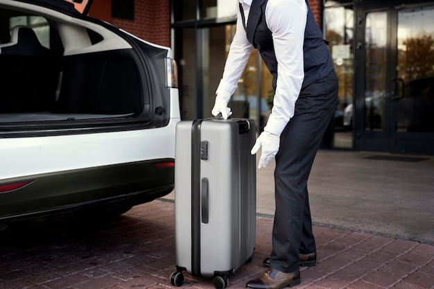 Side view valet holding baggage