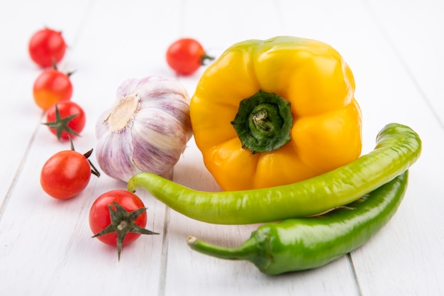 Side view of vegetables as pepper garlic tomato on wood