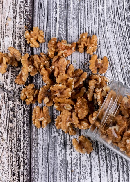 Side view walnuts in jar on wooden vertical