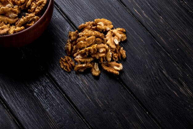 Side view of walnuts scattered on rustic