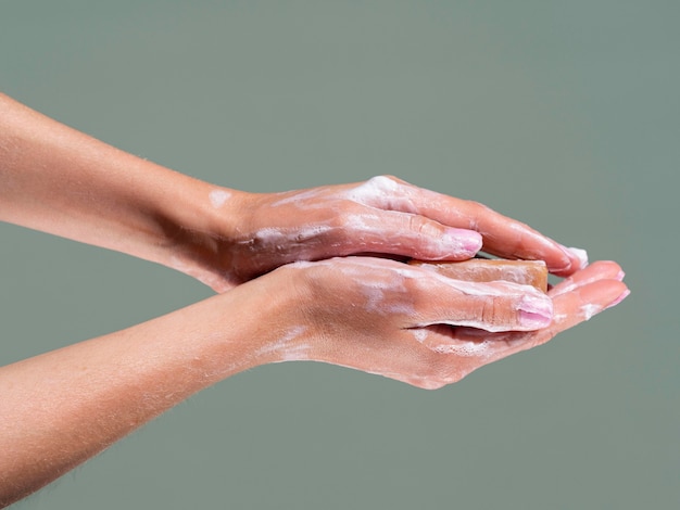 Side view of washing hands with soap