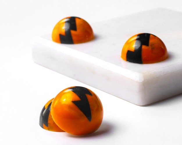 Side view of white chocolate halloween candies on white