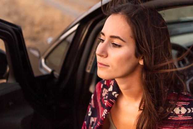 Free photo side view of woman on adventure with car