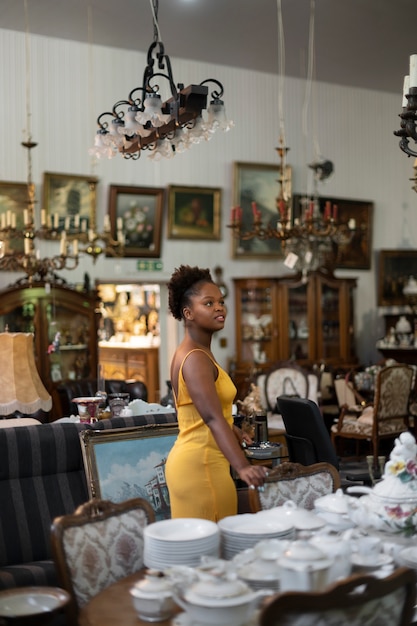 Free photo side view woman at the antique store