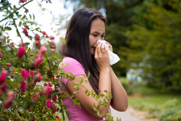 Side view woman blowing her nose