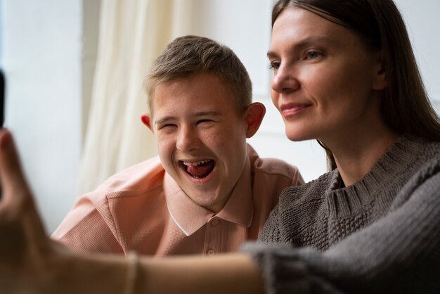 Side view woman and boy taking selfie