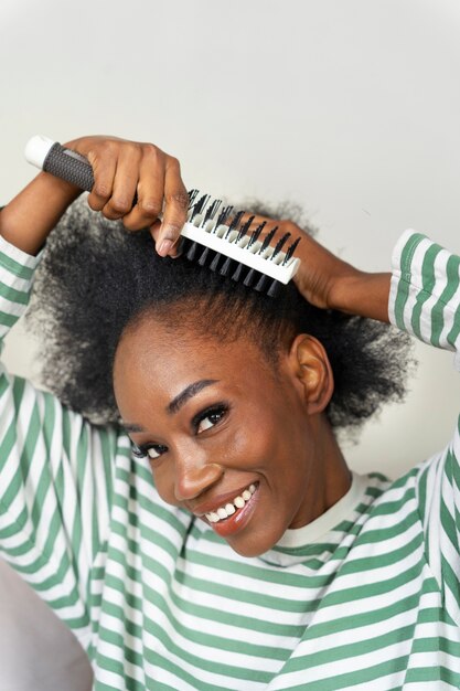 Side view woman brushing hair