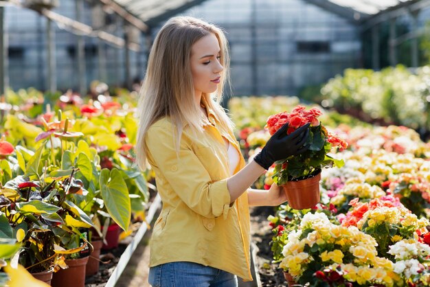 Side view woman caring blossom flowers