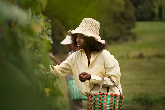 Free photo side view woman carrying basket