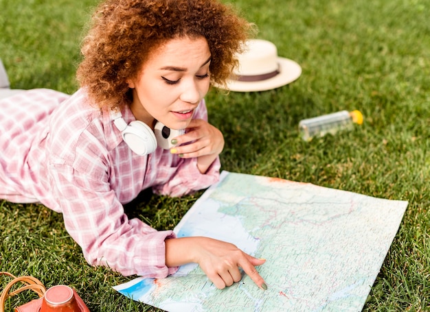 Side view woman checking a map for her new destination