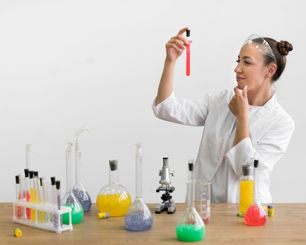 Side view woman checking science tube