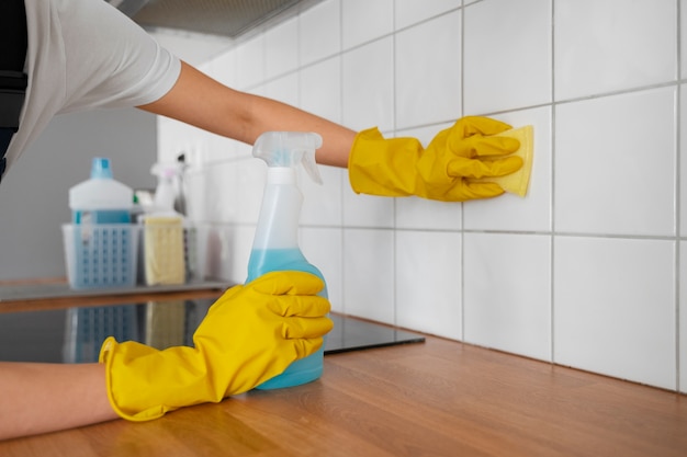 Side view woman cleaning home