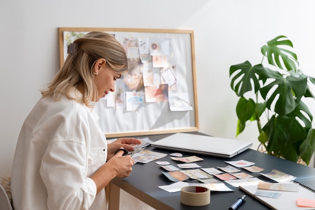 Free photo side view woman creating a vision board