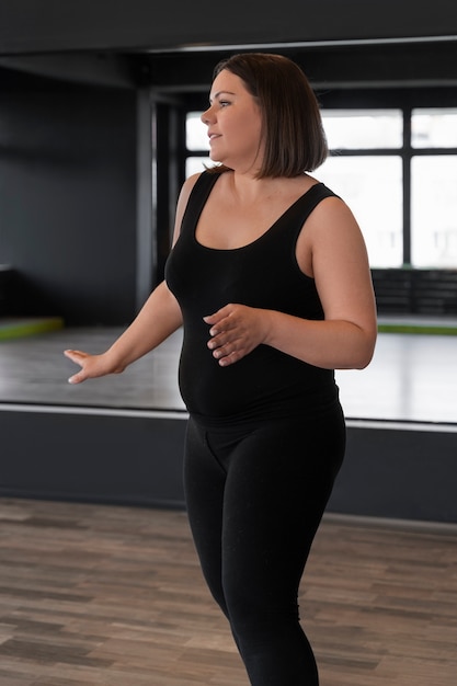 Side view woman dancing in studio