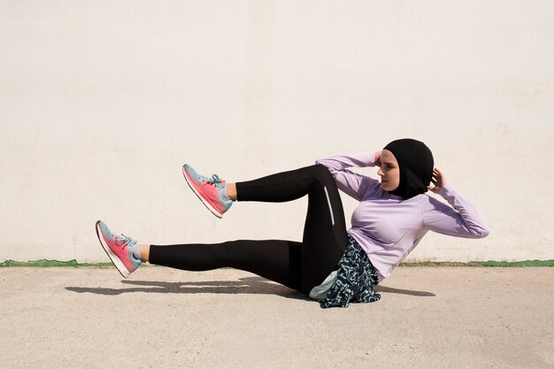 Side view of woman doing bicycle kicks