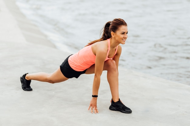 Side view of woman doing lunges