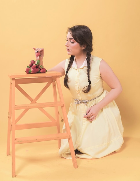 Side view of woman eating strawberries