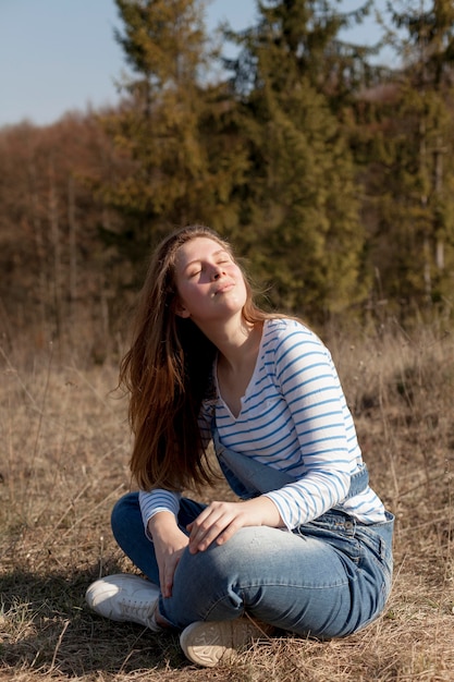 Side view of woman enjoying her time in nature