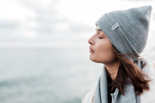 Side view of woman enjoying the ocean breeze with copy space