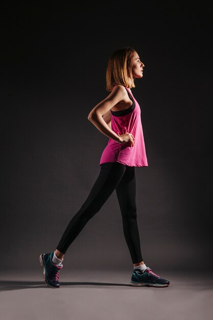 Side view woman exercising in dark room