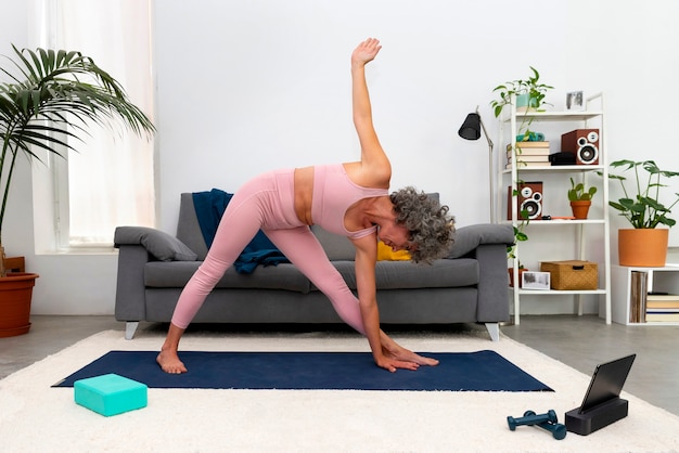 Free photo side view woman exercising at home