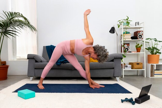 Side view woman exercising at home