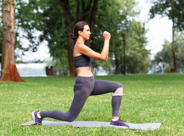 Side view woman exercising outdoors