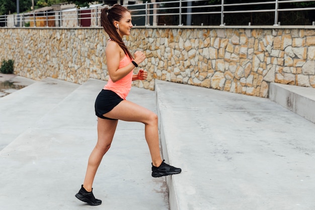 Side view of woman exercising on stairs