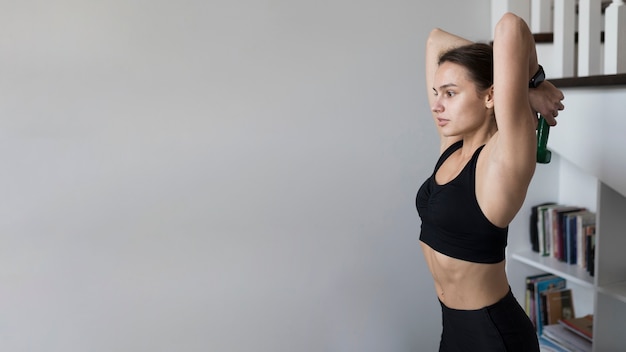 Free photo side view of woman exercising with copy space
