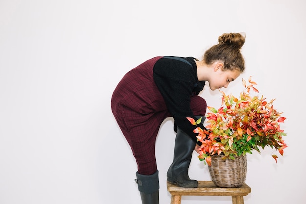 Free photo side view of woman and flowers