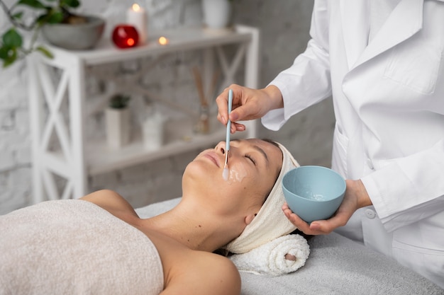 Side view woman getting massaged at spa