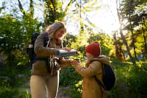 Free photo side view woman and girl exploring nature