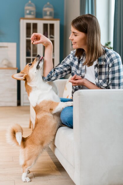 Side view of woman giving her dog a treat