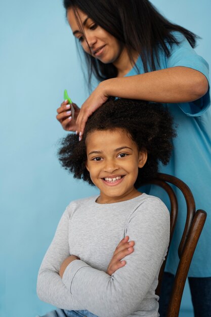 Side view woman helping kid with lice