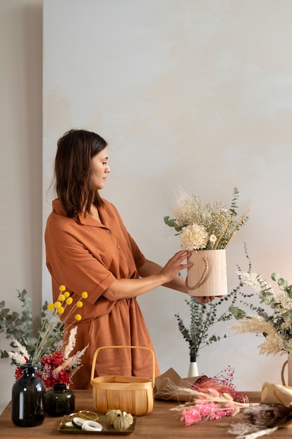 Side view woman holding beautiful flowers