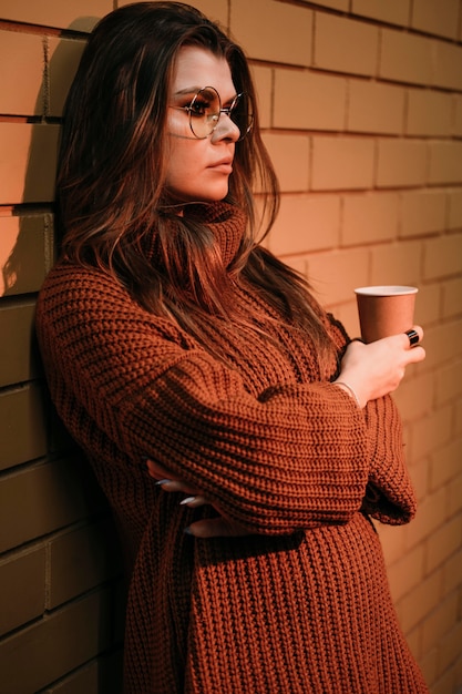 Side view woman holding coffee cup