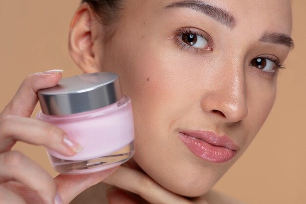 Side view woman holding cream container