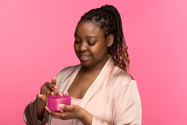 Side view woman holding cream container