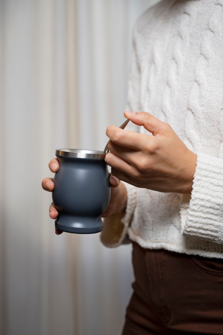 Free Photo side view woman holding cup