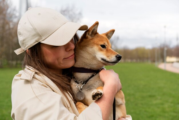 Side view woman holding cute dog