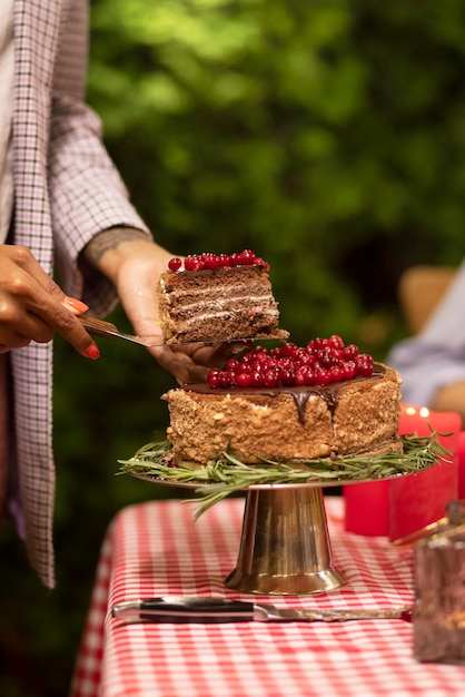 Side view woman holding delicious cake