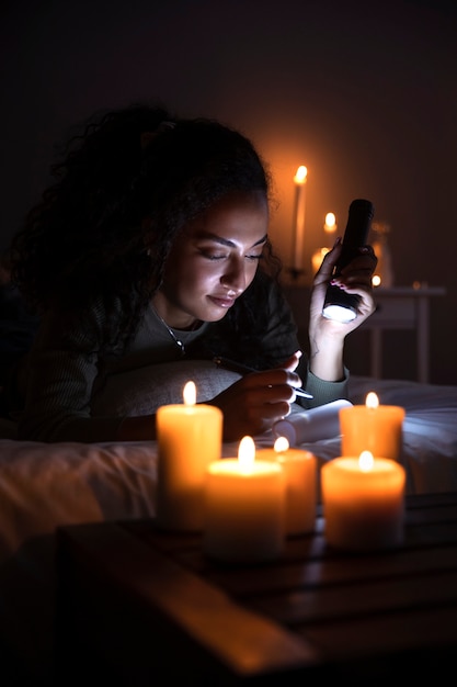 Free photo side view woman holding flashlight