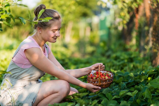 Side view woman holding fruits basket