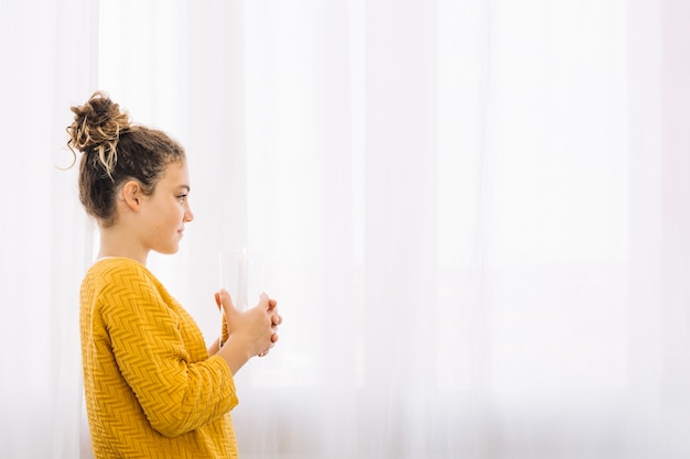 Free photo side view of woman holding glass with seeds