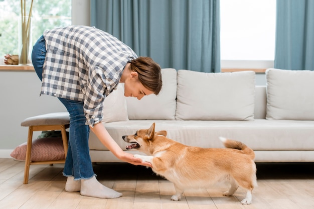 Foto gratuita vista laterale della donna che tiene la zampa del suo cane